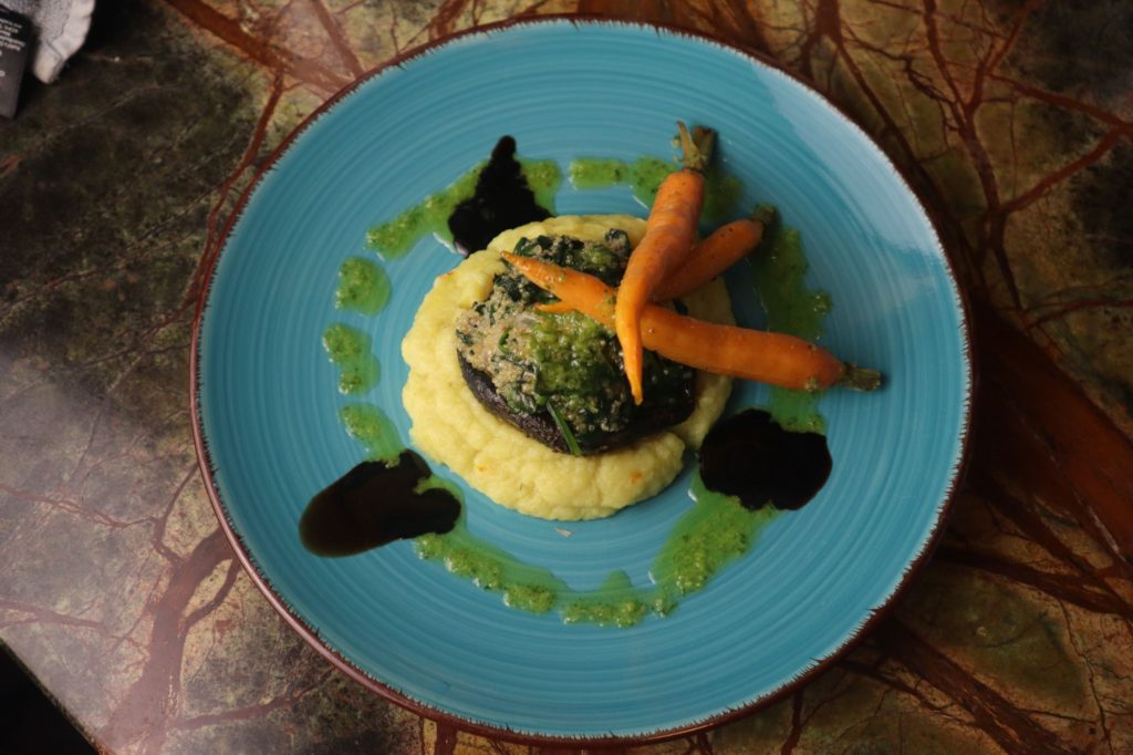 Quinoa and Spinach Stuffed Portobello Mushroom served with Saffron Sunchoke Puree, Roasted Baby Carrots, and drizzled with Balsamic reduction and Basil Oil